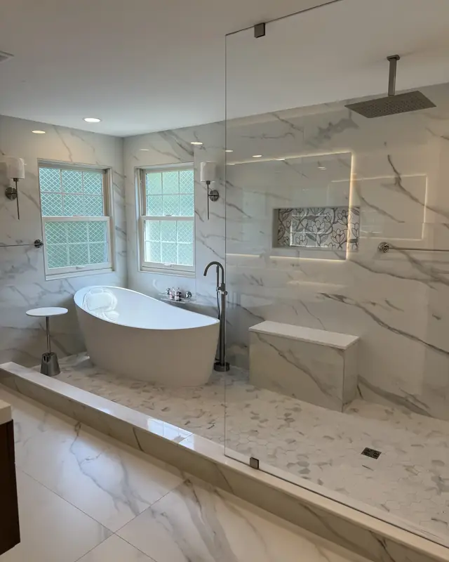 Spa primary bath with a fluted wood wall and walnut-look vanity