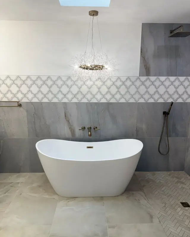 Curbless primary bath with a freestanding tub and champagne bronze fixtures