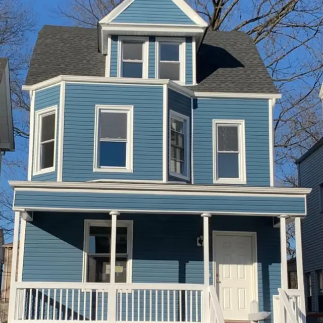 Blue Victorian house after exterior renovation