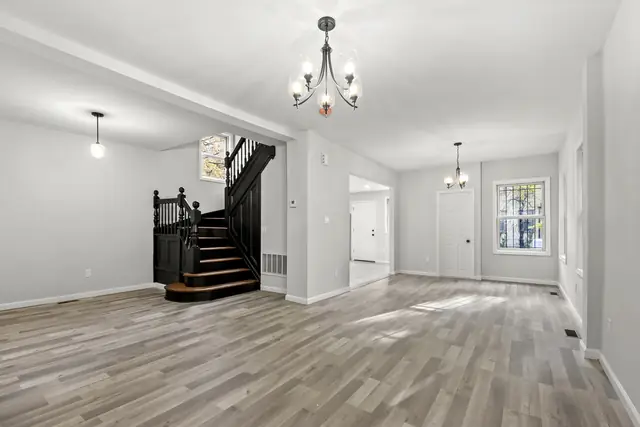 Open living room with new gray plank flooring