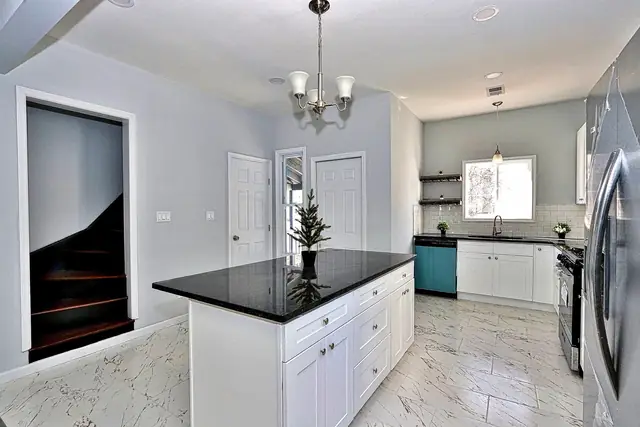 White shaker kitchen with a quartz island