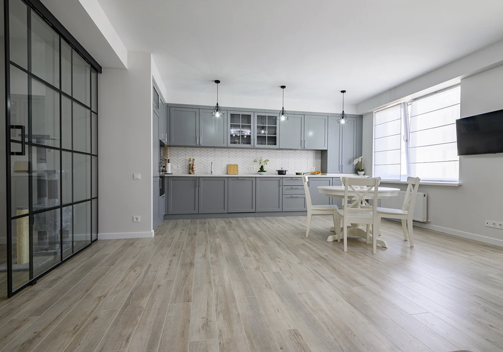 A kitchen with a glossy gray floor